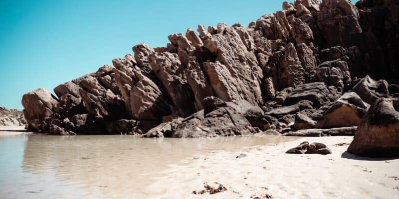 a beach with rocks and a body of water