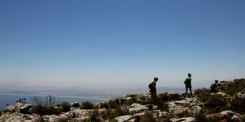 two people walking on rock formation at daytime