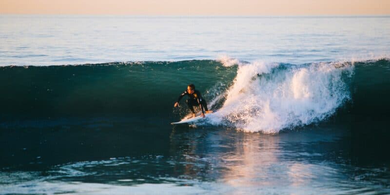 man surfing on ocean wave during daytime